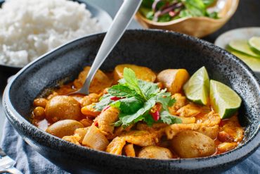 thai massaman curry with chicken and potatoes in bowl